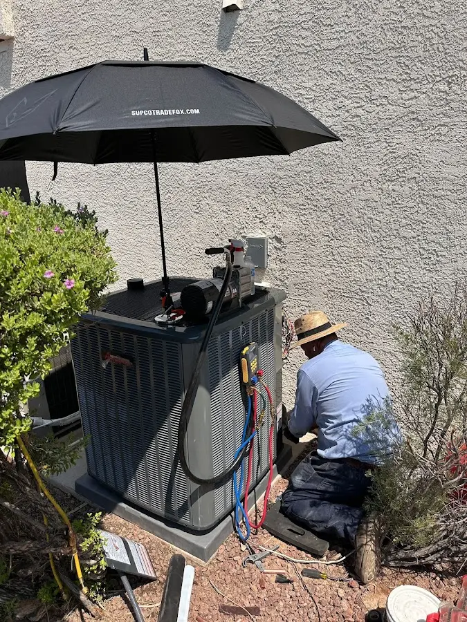 HVAC technician performing outdoor AC maintenance in Country Club